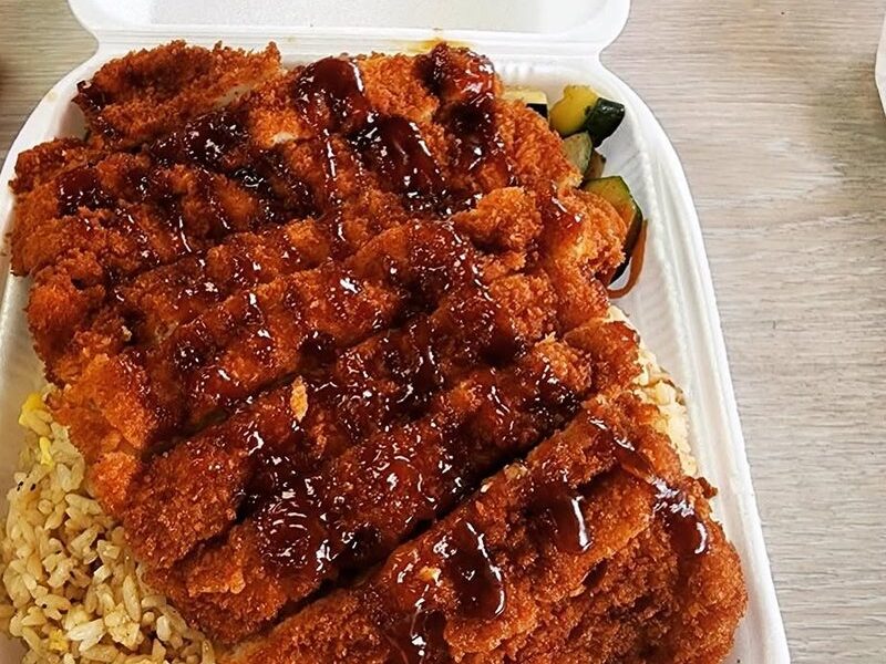 Bamboo Hibachi's chicken katsu, sliced and sauced over egg fried rice in a takeout box